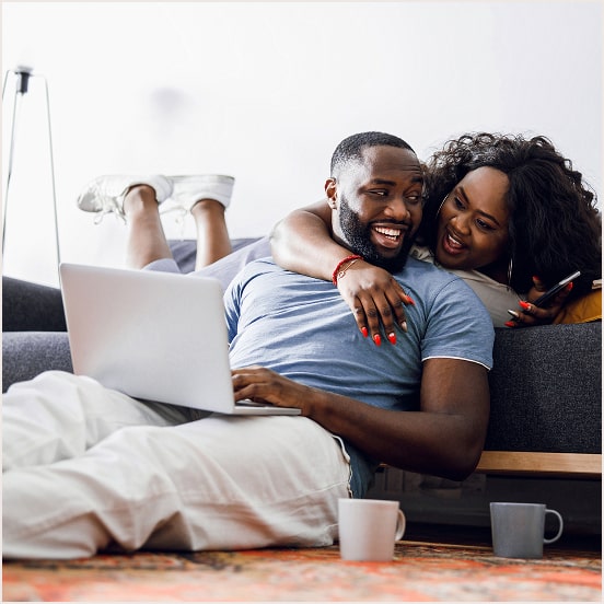 Man holding laptop with his partner