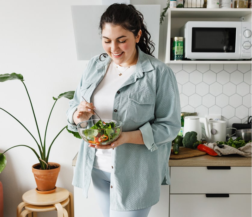 Woman holding a bowl of salad